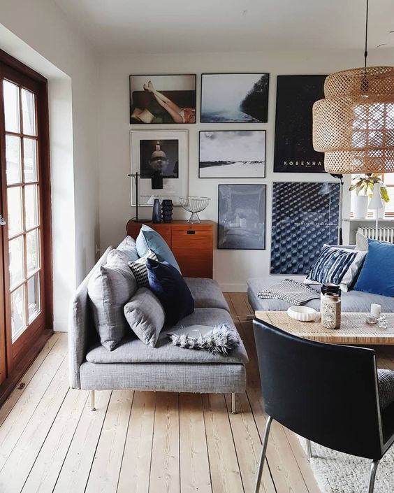 a stylish artwork gallery with art pieces and some photos of the owners