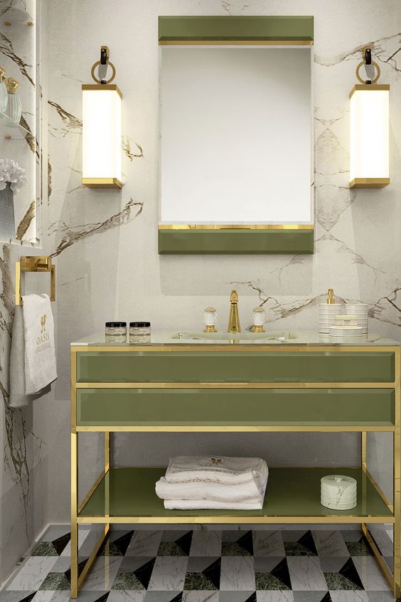 a chic light green vanity and mirror with brass touches are ideal for a luxurious space