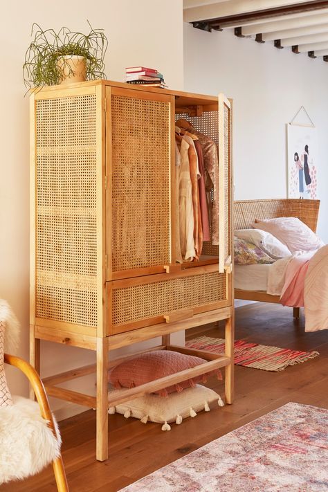 a vintage-inspired wood lettice cabinet is ideal as a wardrobe for a summer home