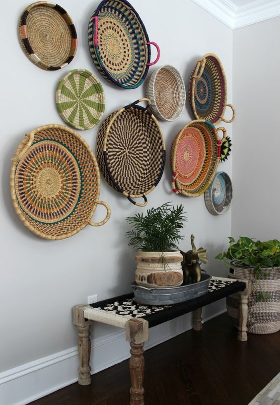 a boho woven and wooden bench, an arrangement of colorful baskets and basket planters