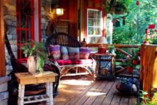 21 a colorful rustic boho porch with bright printed textiles, hanging plants and greenery and rattan furniture