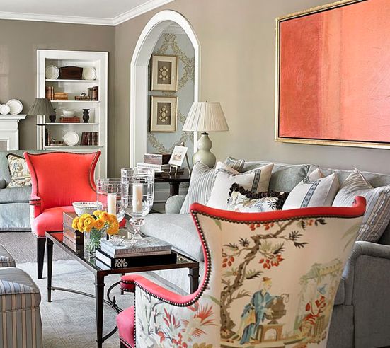 bold chairs with coral fronts and printed backs plus a coral artwork to match the look