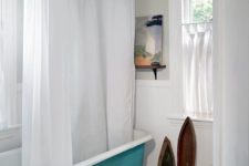 24 a vintage clawfoot bathtub painted turquoise is a great idea to add a chic and colorful touch to a neutral space