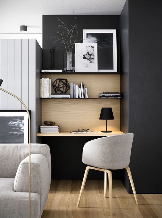 a small yet comfy contemporary home office nook with floating shelves and a desk in the corner of the room