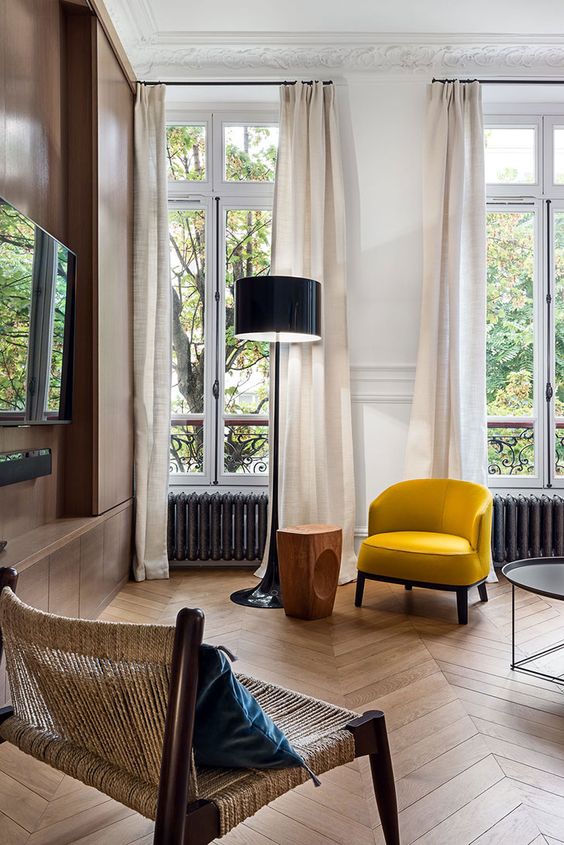 highlight the hihg ceilings with light curtains and molding on the ceiling