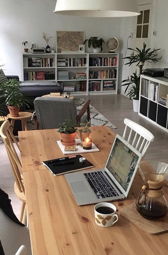 https://www.digsdigs.com/photos/2018/05/a-stylish-modern-living-room-with-grey-furniture-IKEA-storage-units-potted-plants-and-a-table-with-chairs-for-working.jpg