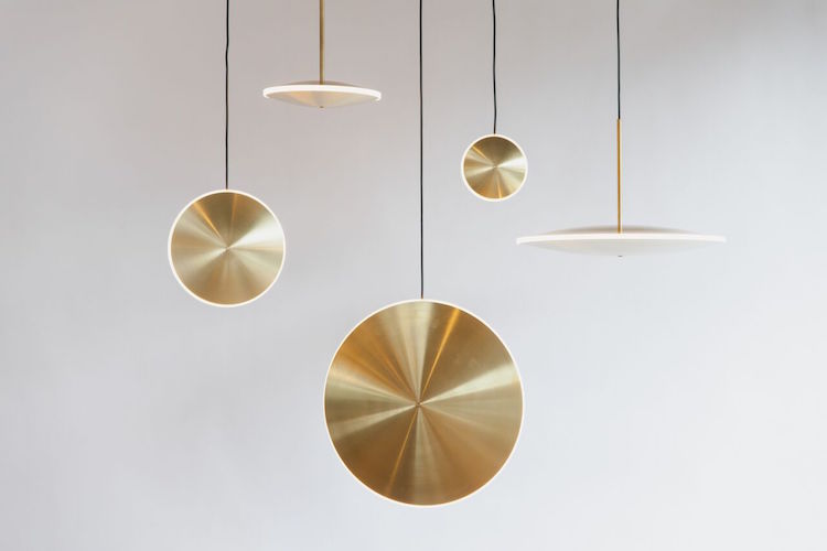 brass pendant lamps Each piece is made of spun brass and diffused acrylic and each lamp can be hung placing the disk vertically and horizontally