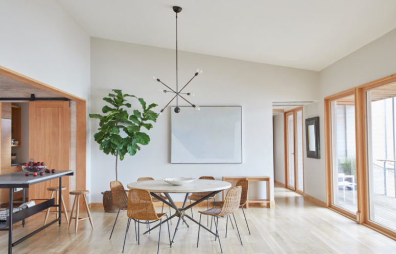 kitchen decor with wicker touches The dining space shows off a cool round table and wicker chairs for an outdoor feel