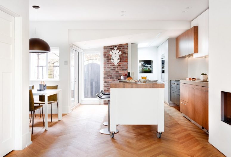 The kitchen is the main space of the house, whose owners are two chefs, and it takes the main part of the footage together with the dining space