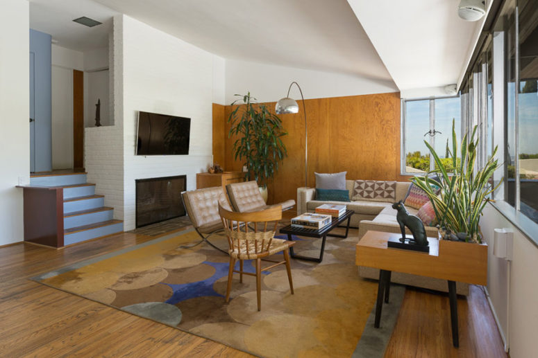 built in fireplace below the tv The living room features a built-in fireplace, a plywood, a glazed and a brick wall plus a fine furniture selection