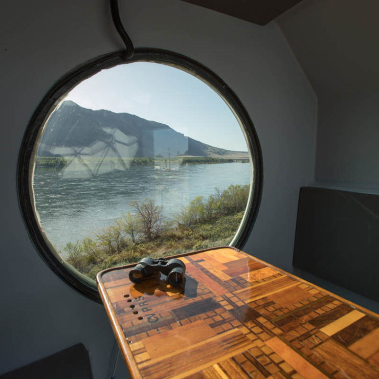 geometric dining space by an illuminator Inside you may see a comfy dining space with built-in benches and a table next to an illuminator