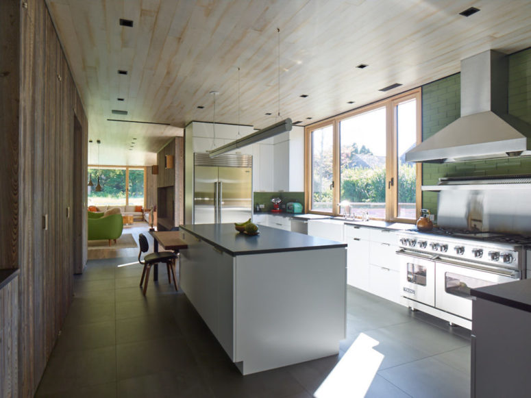 white kitchen design The kitchen is done with white cabinets, there's a large window that lets the views