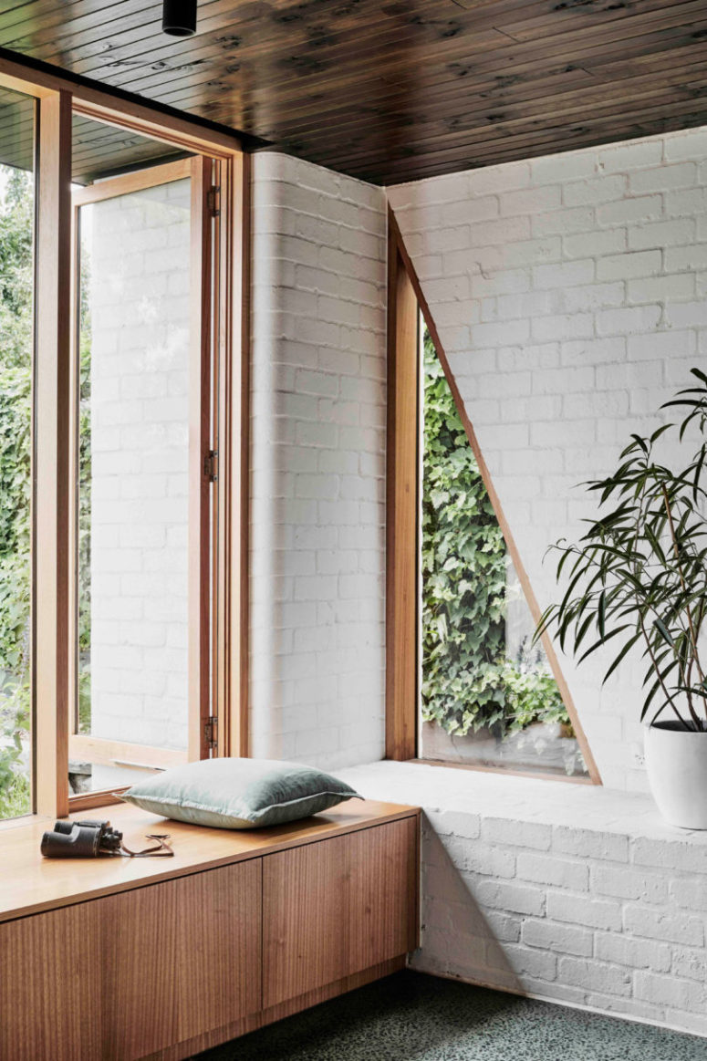 There's a large window and a couple of triangle cutouts for connecting the space to outdoors and fill it with natural light There's a large window and a couple of triangle cutouts for connecting the space to outdoors and fill it with natural light