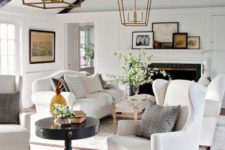 03 a fresh take on a farmhouse interior with two white sofas and black wooden beams for a contrast