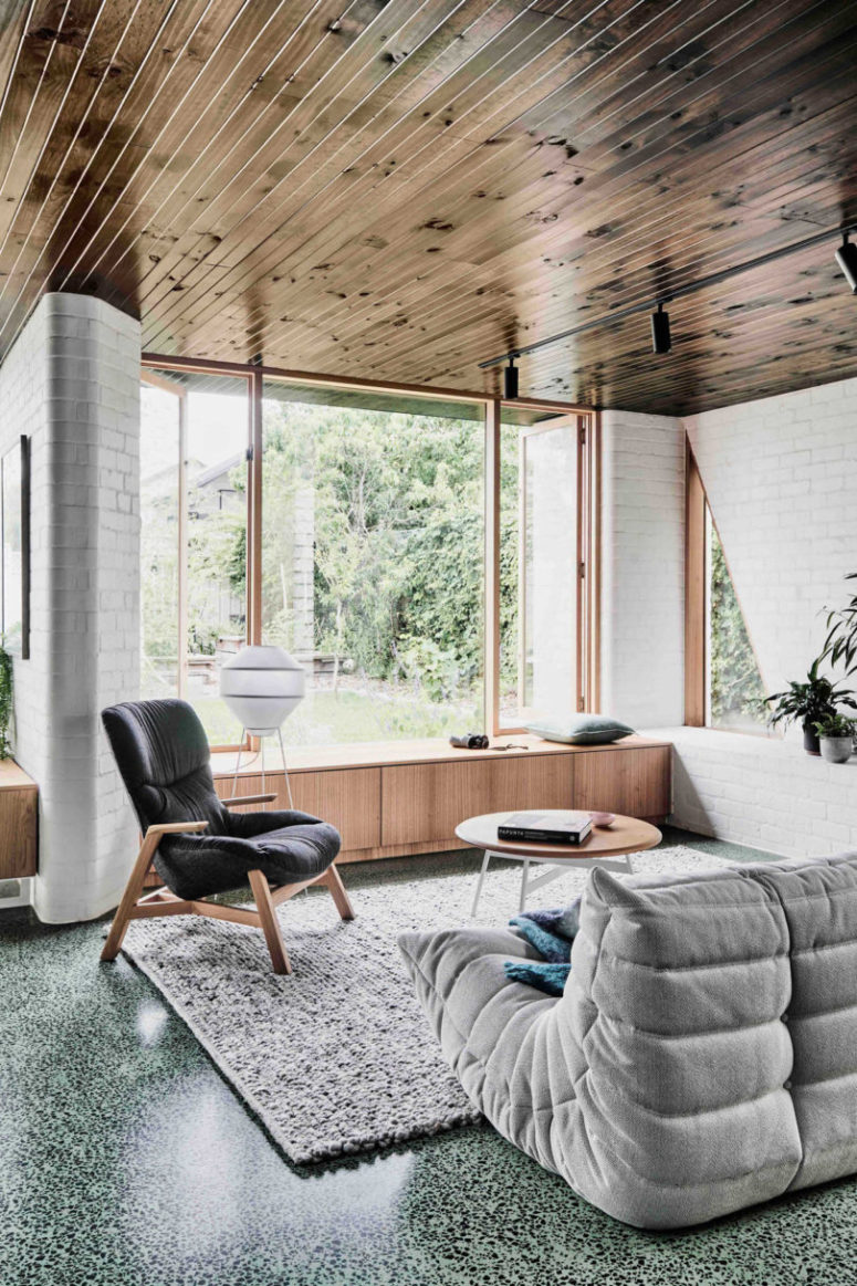 window with a loveseat near by The furniture is modern and comfy, an upholstered loveseat and a comfy chair plus a coffee table, all in perfect harmony with each other
