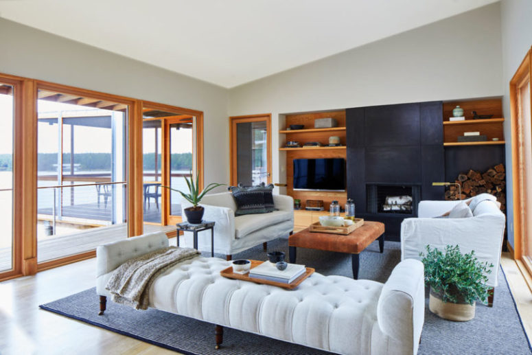 The living room is done with chic white upholstered furniture, wooden touches and is filled with light The living room is done with chic white upholstered furniture, wooden touches and is filled with light