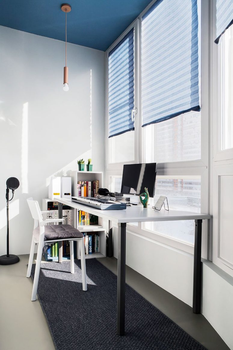 freelance workspace by the window The working space is placed by the window to fill it with light, there's a large desk and some box shelves in the corner