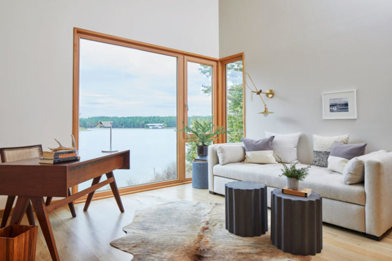 The home office is done with a retro desk and a wicker chair, with a sofa and features amazing views The home office is done with a retro desk and a wicker chair, with a sofa and features amazing views