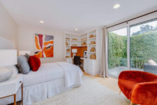 05 The second bedroom is accented with orange touches and looks very bright and shining
