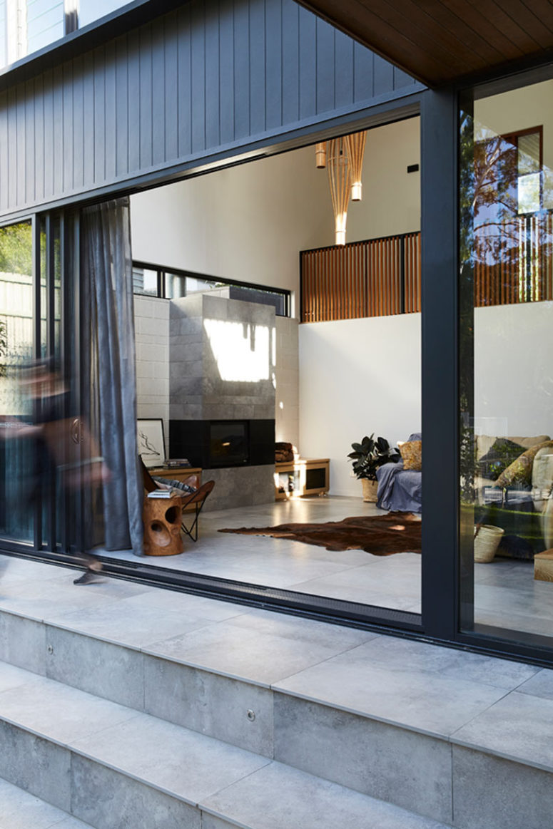 The living room is done with a modern built in fireplace, comfy furniture and textiles, tiles are widely used here to make the space not so hot The living room is done with a modern built-in fireplace, comfy furniture and textiles, tiles are widely used here to make the space not so hot
