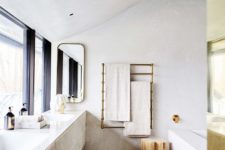 07 The bathroom is clad with quartz and brass spruces it up to look more glam