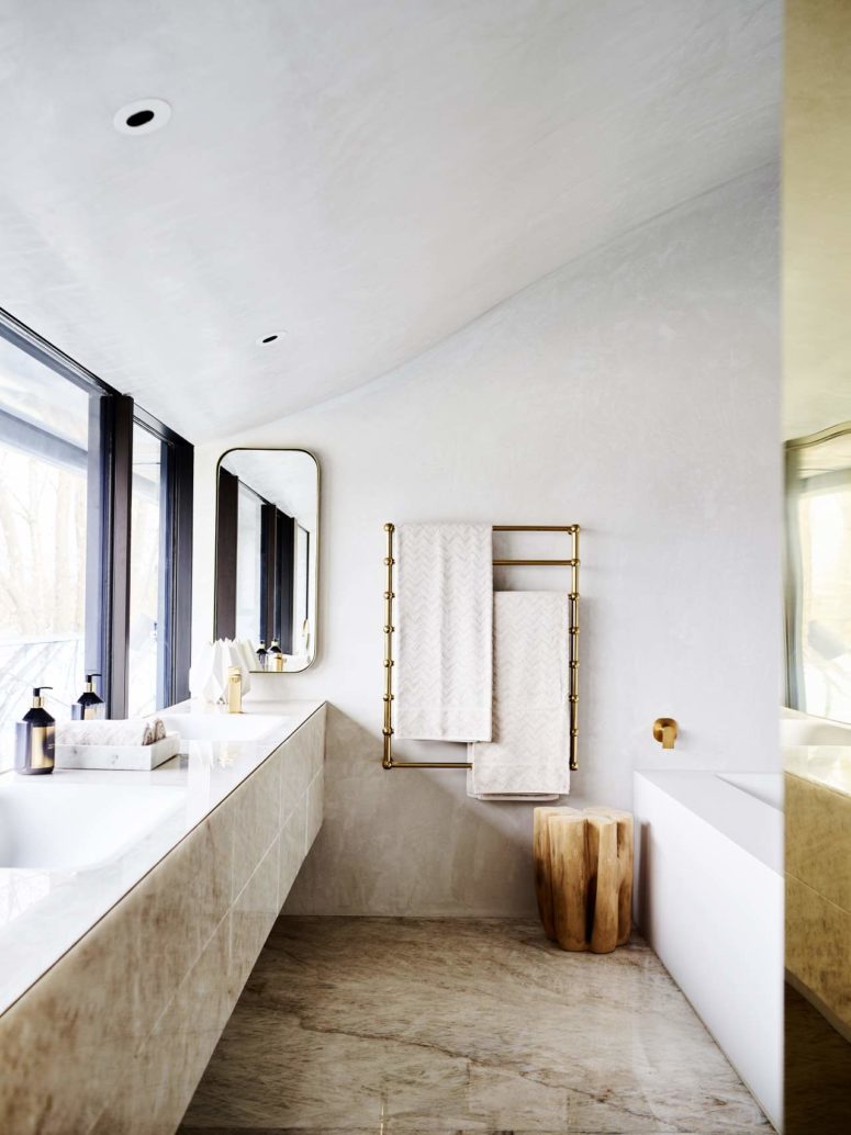 The bathroom is clad with quartz and brass spruces it up to look more glam
