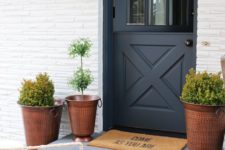 07 a chic entrance with hammered copper planters and a graphite grey Dutch door