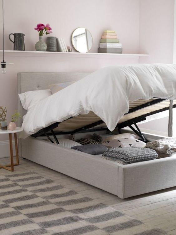 bed used as storage to keep a room uncluttered