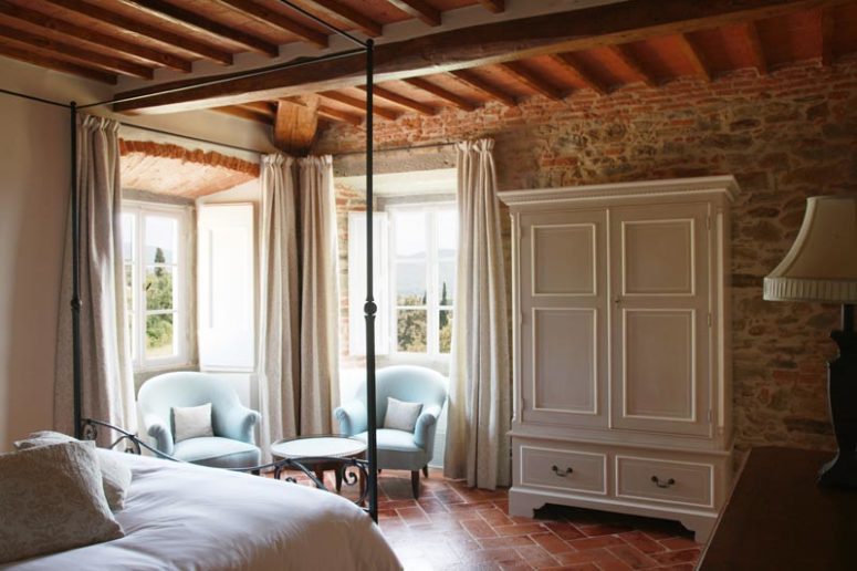 gorgeous canopy bed for a cozy bedroom The next bedroom is done with a forged canopy bed, a large wardrobe and features masonry