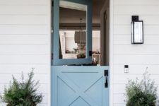 09 a contemporary beach entrance with a blue Dutch door and symmetrical pots with succulents