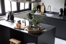 09 grey plaster wall with black sleek cabinets for an ultra-modern Scandinavian kitchen