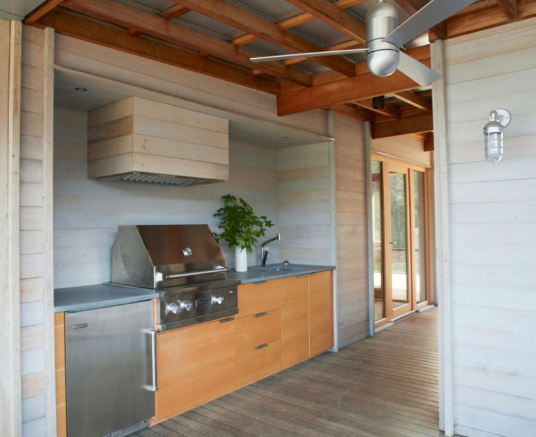 cool outdoor kitchen that features reclaimed wood There's also an outdoor kitchen done of reclaimed wood