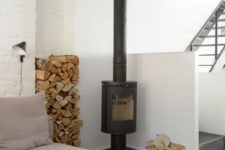 11 There’s a hearth with firewood storage, which adds coziness to the space, too