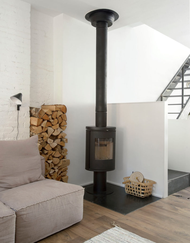 There's a hearth with firewood storage, which adds coziness to the space, too