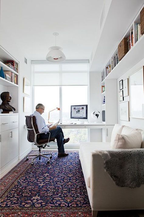 a built-in desk and bookshelves by the window and a daybed that becomes a sleeping space