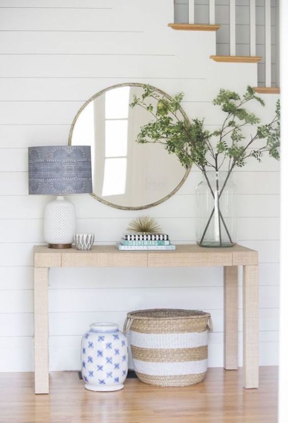 a simple summer console, greenery in a jar, baskets and a blue lampshade for an airy and serene look