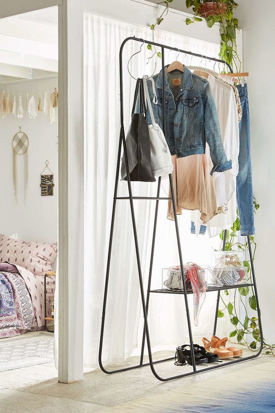 an airy yet stable metal coat rack with clothes and shoes doesn't look bulky