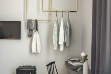 11 stylish brass pipe racks attached to the ceiling look super stylish and spruce up the grey space