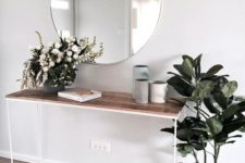 12 a minimalist summer console table with lush blooms in a vase and a potted plant in a basket – you won’t need more