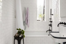 13 The bathroom is done with white tiles with black grout for a chic and otustanding look