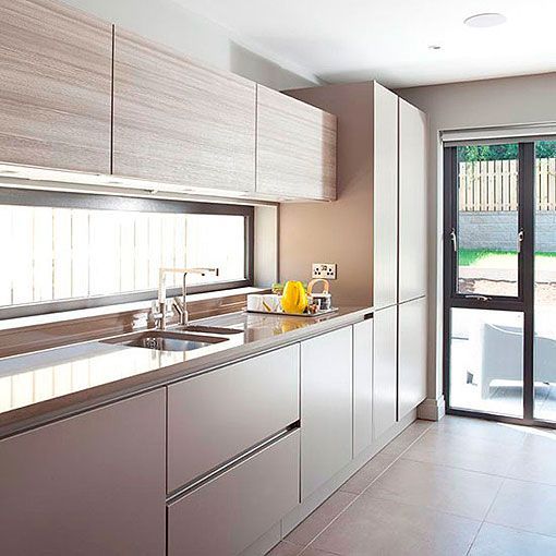 a neutral kitchen with sleek and wooden cabinets plus a window backsplash for more light