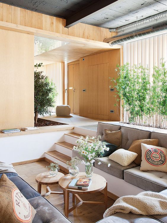 a small sunken living room with a built-in bench for a cozier and more private feel