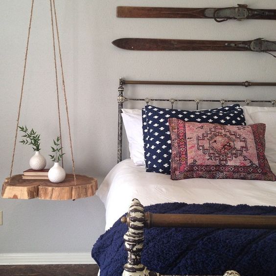 a natural hanging bedside table of rope and a raw edge wood piece for a rustic space