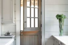 all white kitchen design with a rustic door