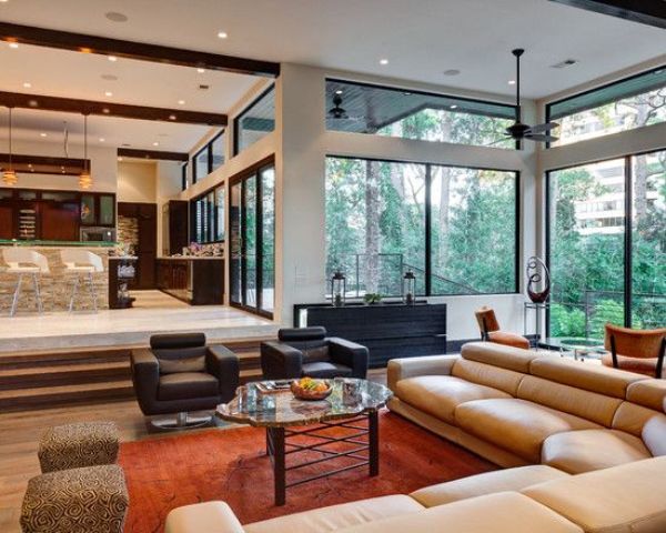 a mid-century modern sunken living room with elegant furniture and much light coming through windows