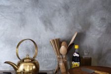 19 a grey plaster backsplash, brass and wood create a fantastic ambience in the kitchen