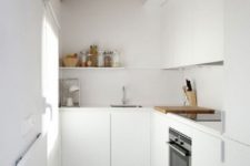 20 a minimalist white kitchen with a wooden ceiling and a window to make the space ethereal