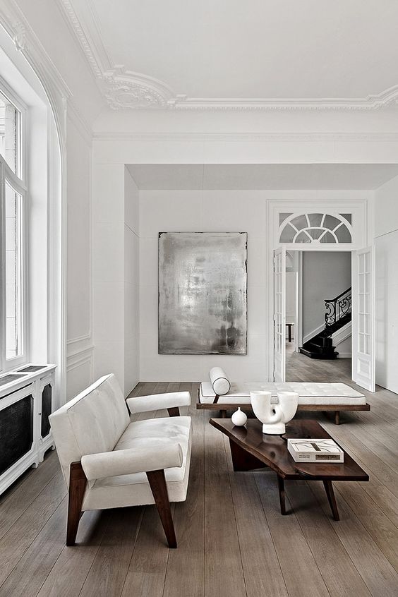 a unique mid-century inspired white sofa with dark wood details for a bold sophisticated look