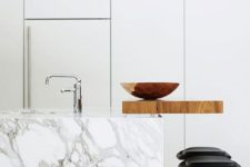 22 a kitchen island of white marble with an additional wooden countertop to use for having meals and drinks