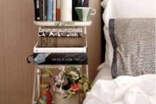 22 a small vintage ladder acts as a bedside bookshelf and doesn’t cost a lot of money